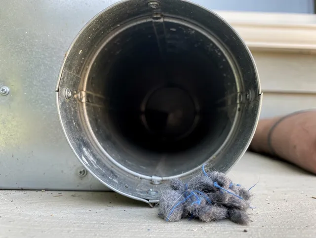 Inglewood Dryer Vent Cleaning technician using specialized equipment to clear severe dryer vent blockage in Inglewood